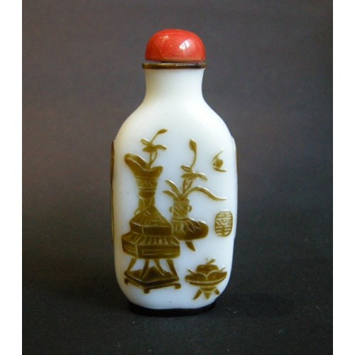 Snuff bottle overlay glass Brown on white ground sculpted with a mobilar decor Yangzhou school